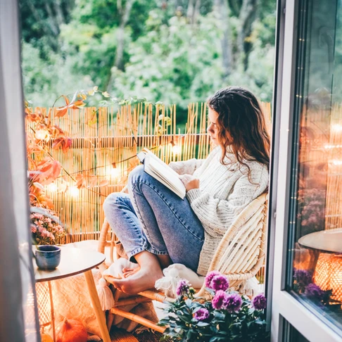 woman reading next to nature