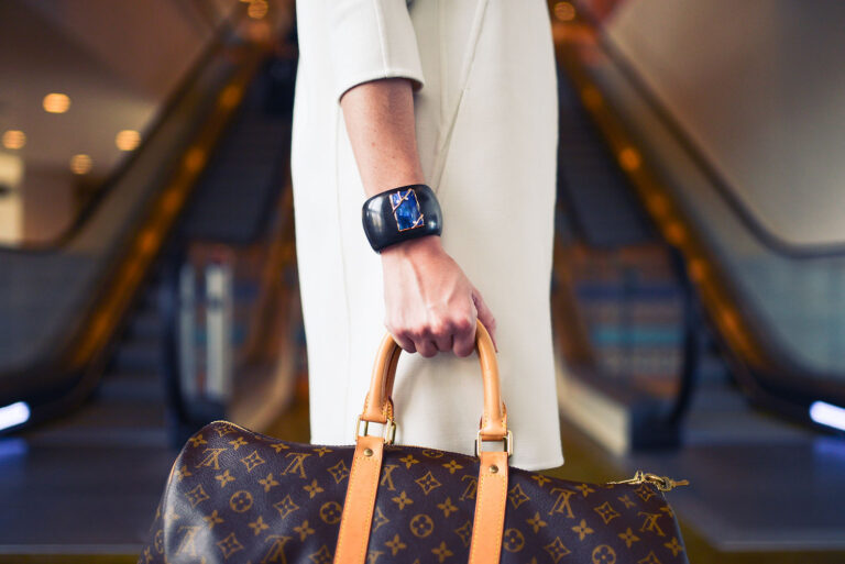 Woman holding a luxe weekender overnight bag