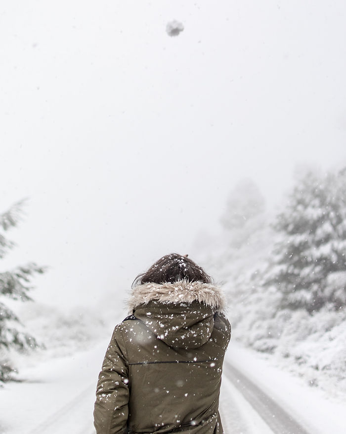 self reflection for winter journal prompts for adults. a girl reflecting about life on a snowy road