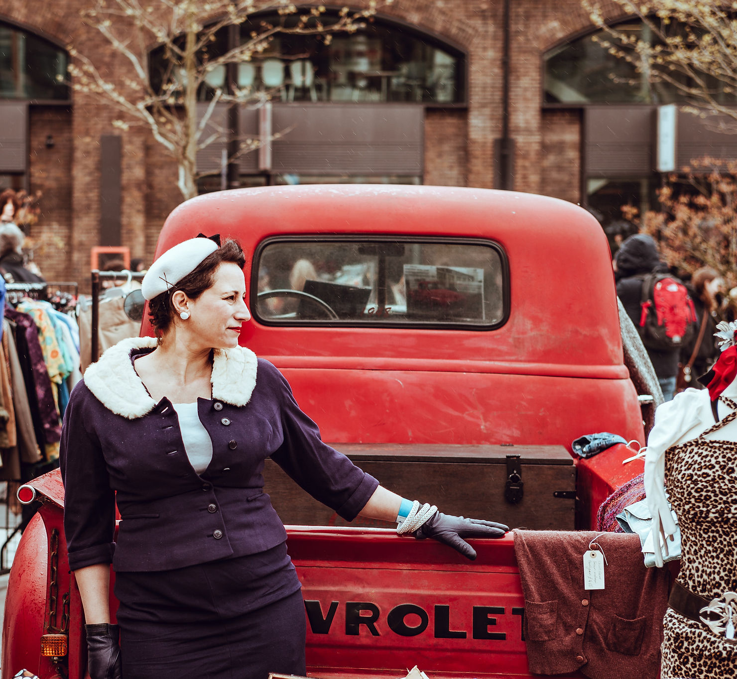 Nostalgic Jewelry: Retro & Vintage Inspired Designs for Earrings, Bracelets, Rings and Necklaces woman standing wearing nostalgia jewelry in front of a red vintage car