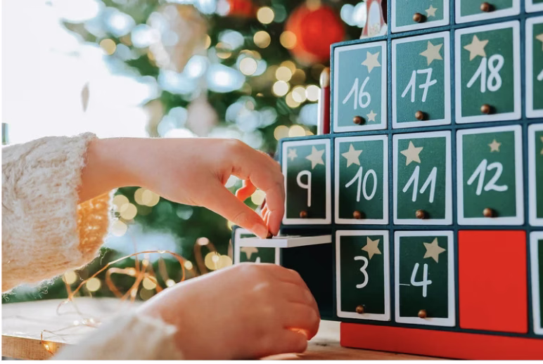 hand opening an advent calendar