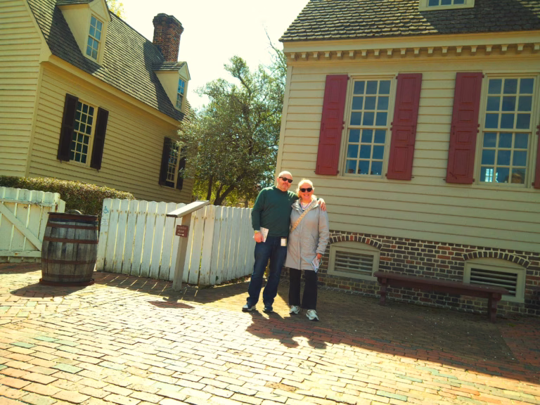 two people stnading in front of a white building