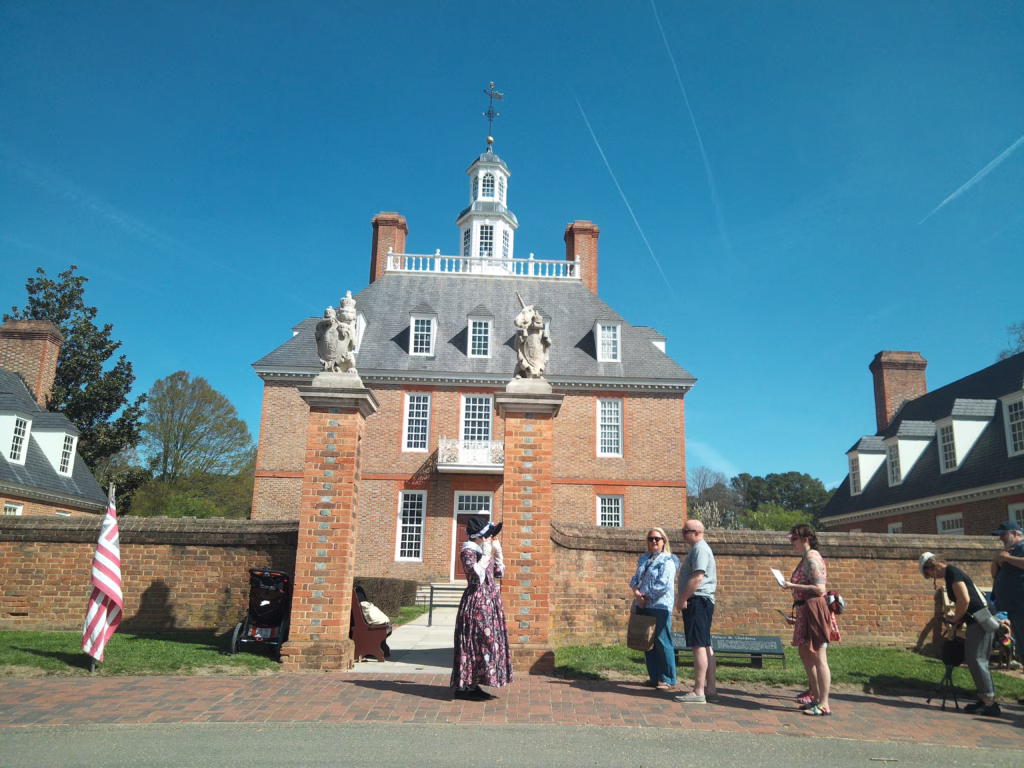 people stnading in front of a palace type building in williamsburg virginia