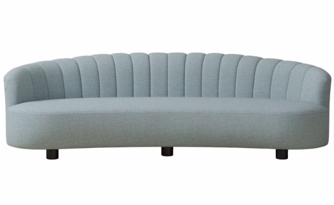 blue curved sofa with tufted back
