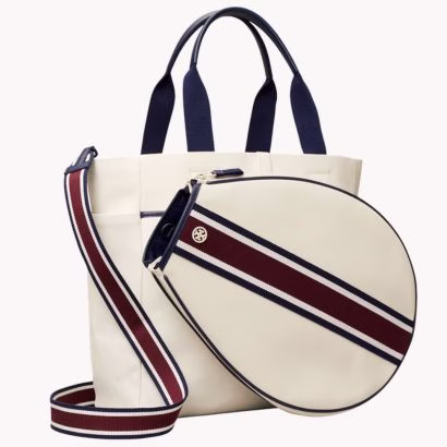 white tennis bag with red and blue stripes and a blue top handle by tory burch