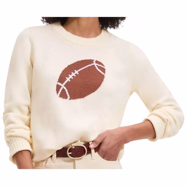 cream sweater with football in the middle
