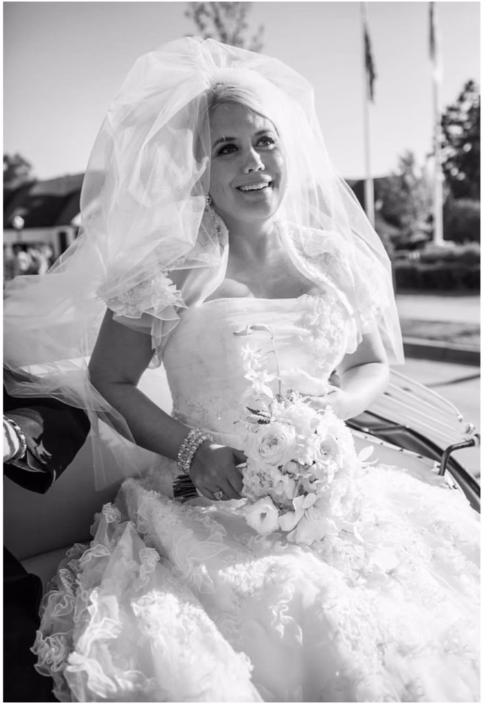 black and white photo of a bride in wedding dress and veil