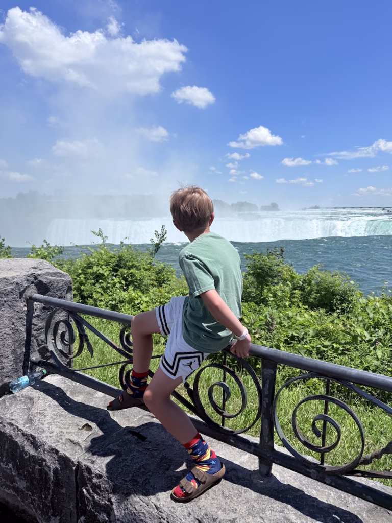 boy looking at Niagra Falls