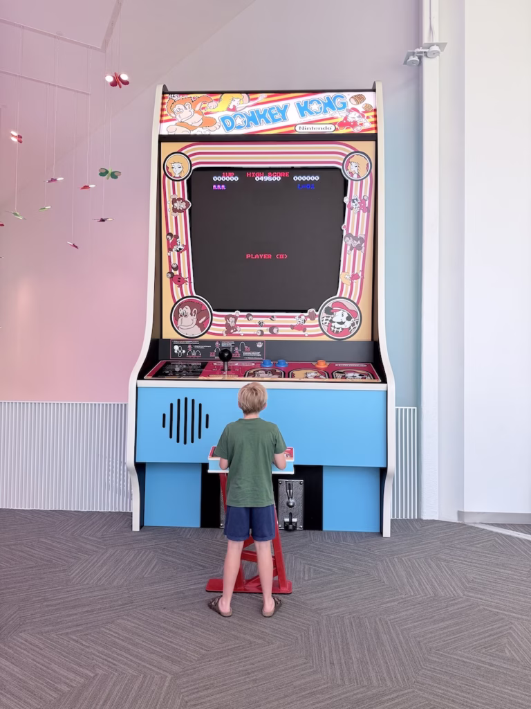 boy playing an oversized donkey kong video game