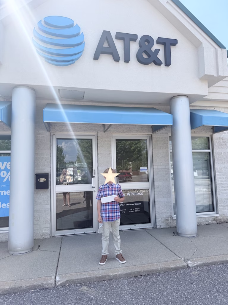 boy standing in front of an AT&T store