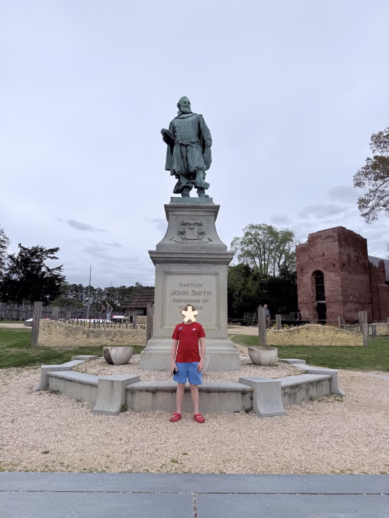 boy standing in front of captain john smith at jamestown