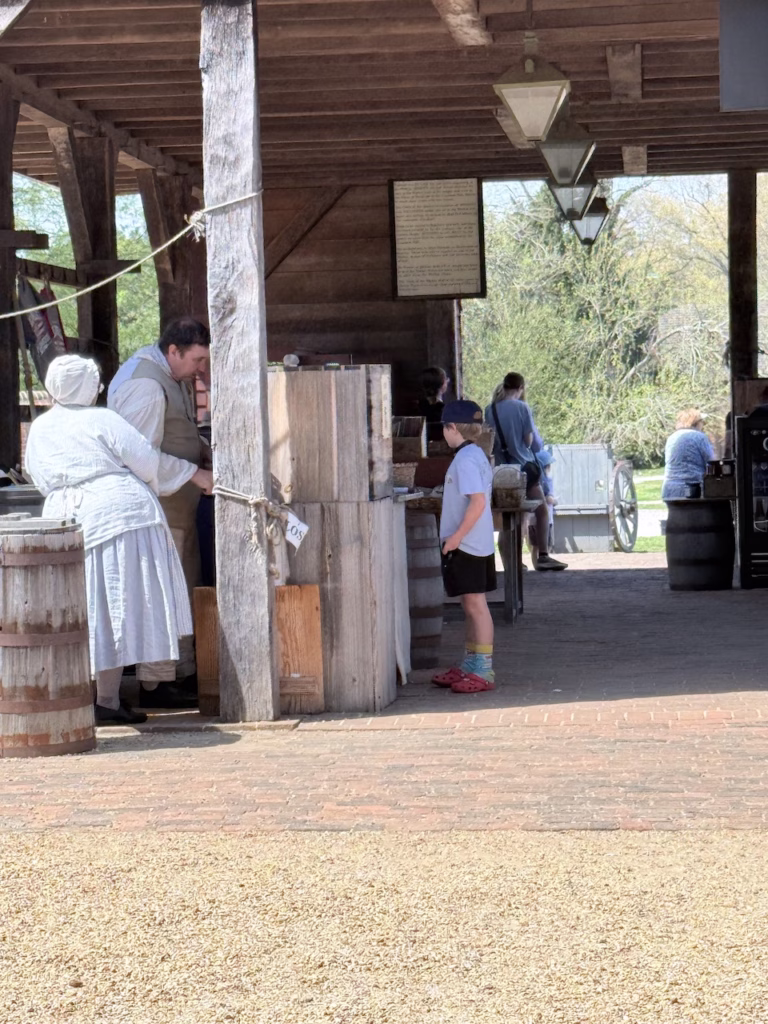 buying a hat at the open air market at colonial williamsburg