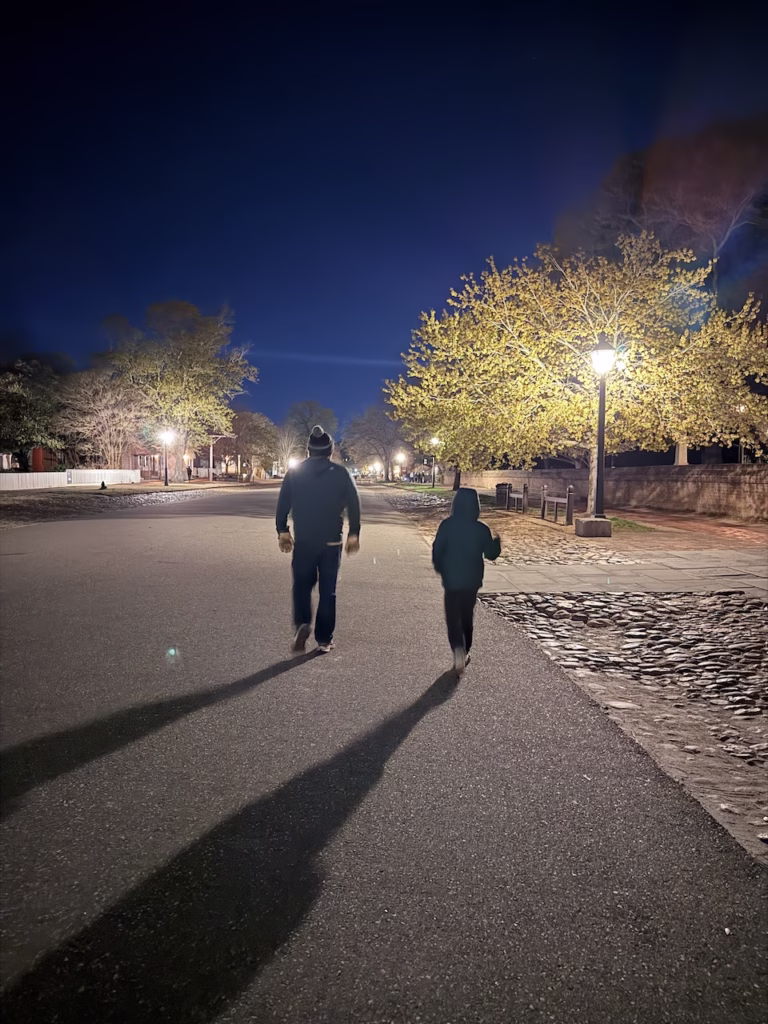 haunted ghost tour dad and son walking in williamnsburg