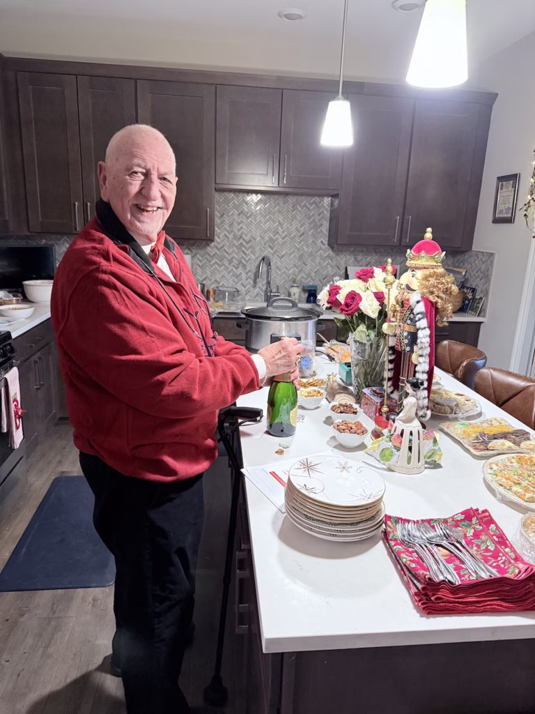 man standing in kitchen at christmastime