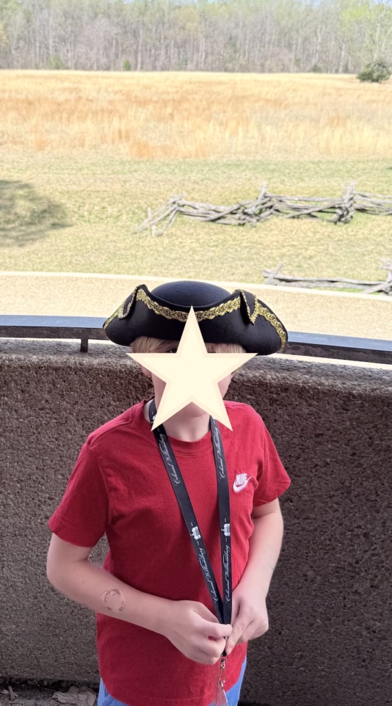 young boy standing at hte site of the yorktown battlfield surrender