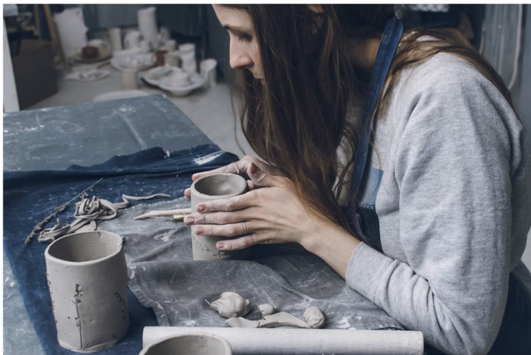 woman sculpting clay