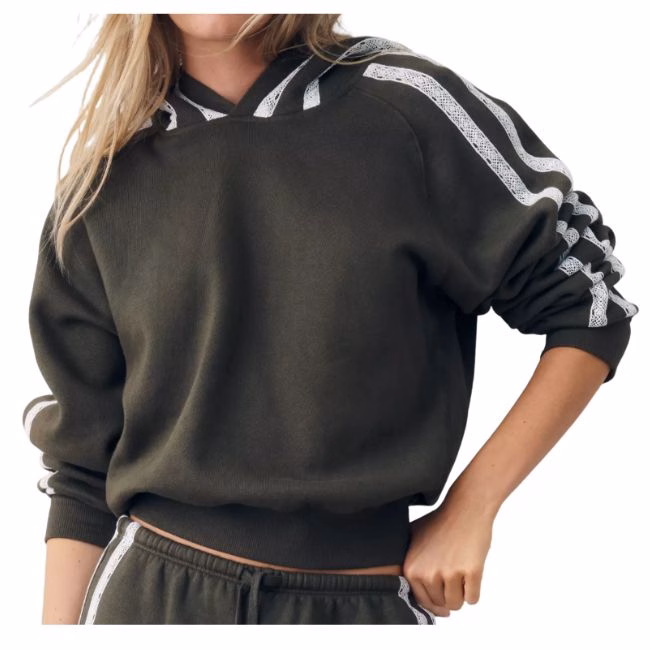 cropped sweatshirt with stripes on her sleeves