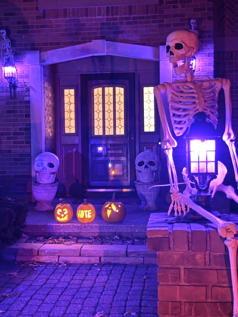 pumpkins in front of spooky house door