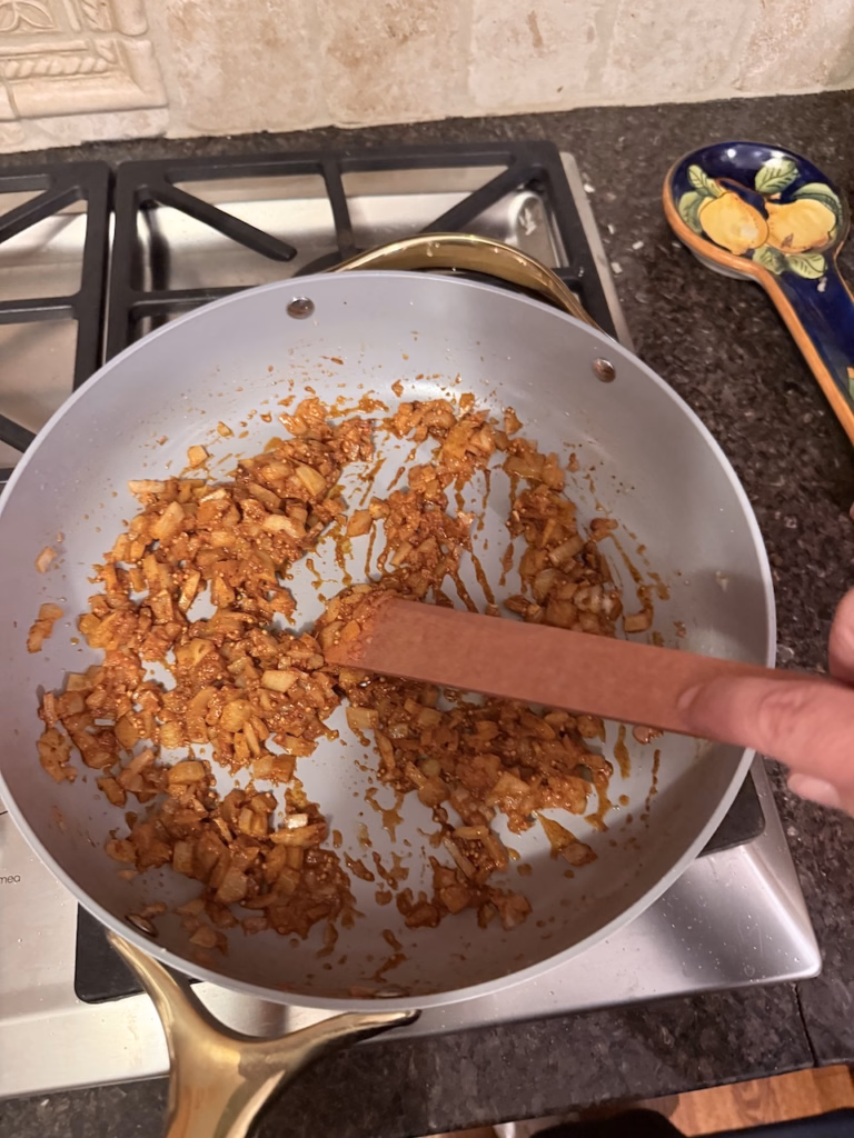 simmering onions and spices for butter chicken meatballs